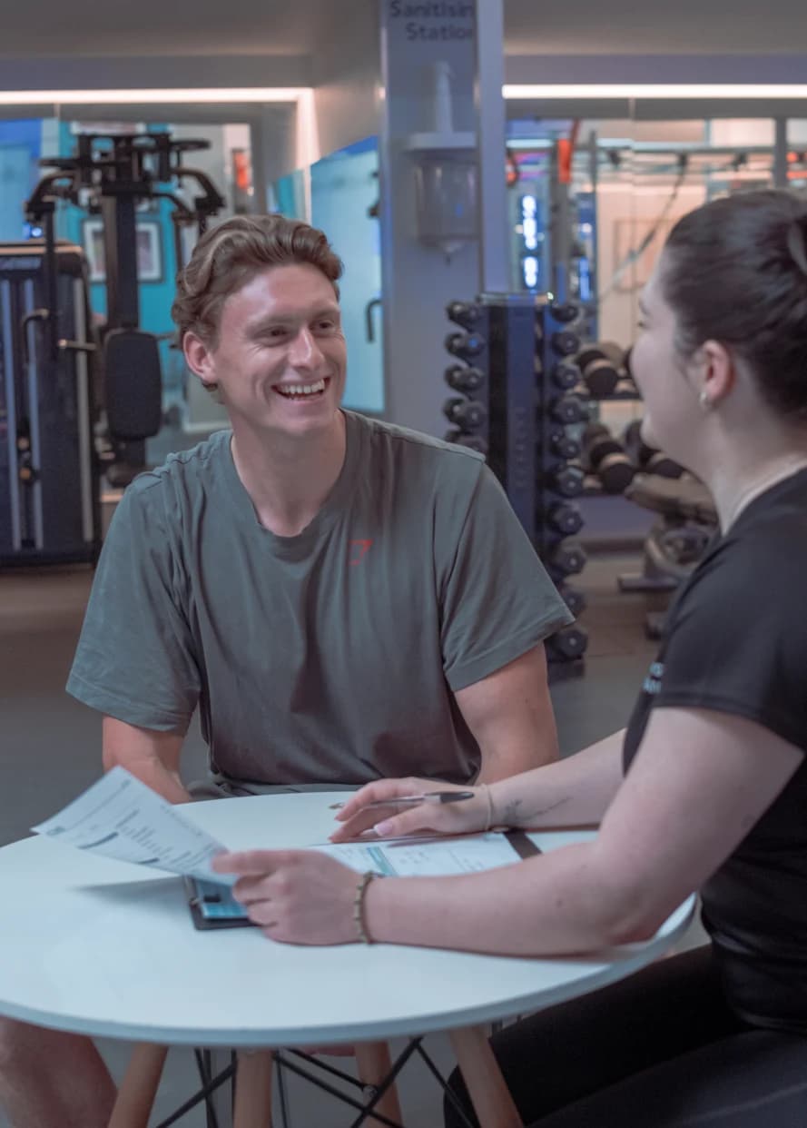 Member consultation at a table in the gym at Body Works West