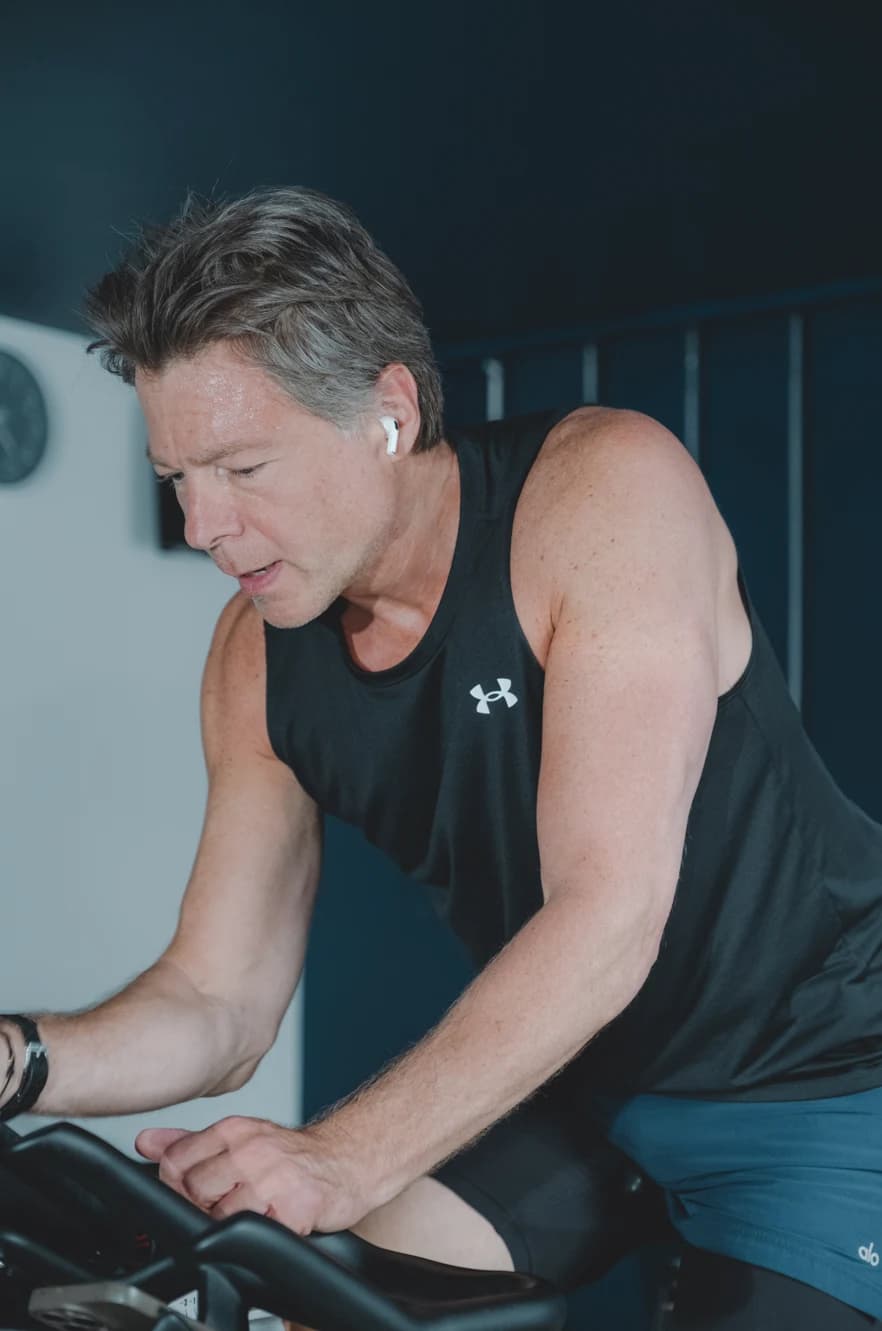Man cycling on a spin bike at Body Works West