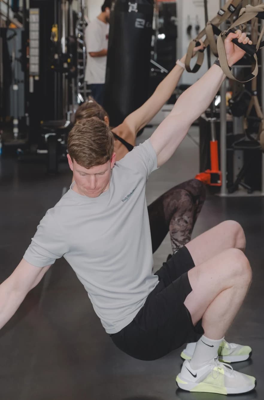 Man using TRX suspension straps at Body Works West