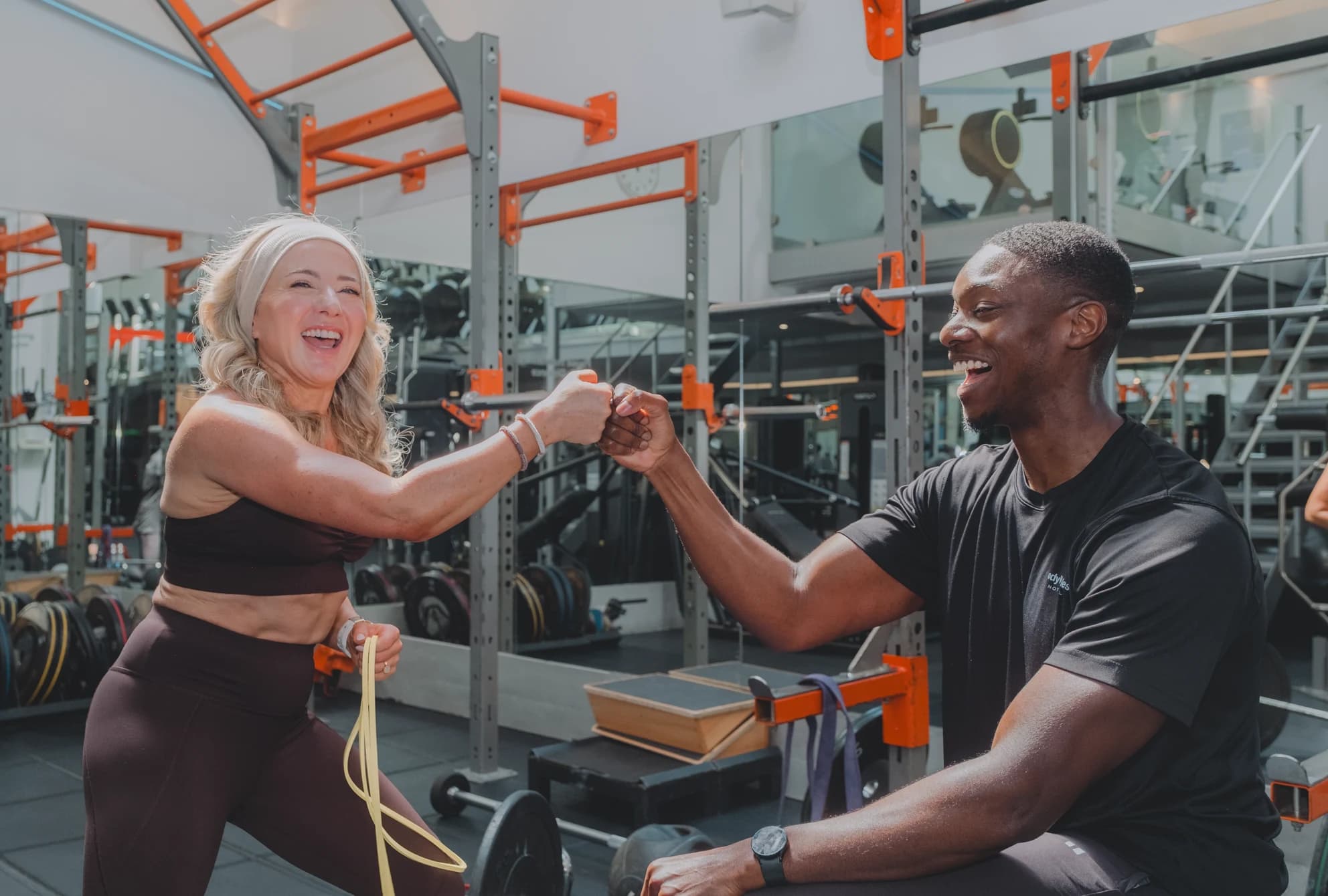 Personal trainer and member fist-bumping during a training session at Body Works West