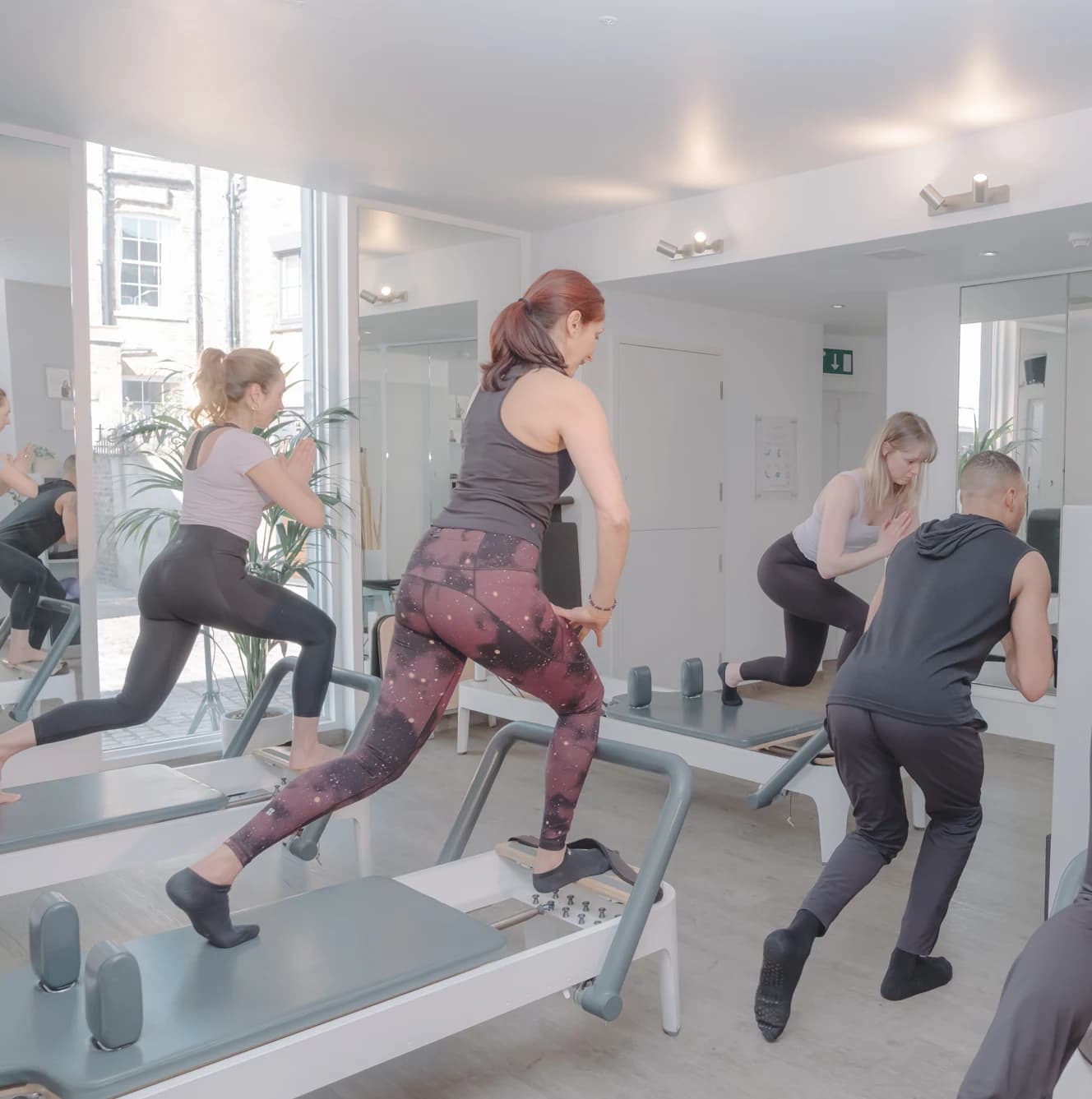 Members using Pilates reformer machines at Body Works West